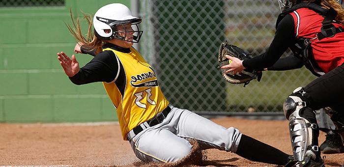 MCC Lady Tribune softball player sliding into home plate.